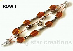 Amber Czech glass beads, antique silver beads and brown iris beads on Greek Leather and a magnetic clasp comprise this 3-strand design.For more details... close this window and click on 
