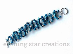 Turquoise chips woven together with antique silver findings and secured with a toggle clasp.